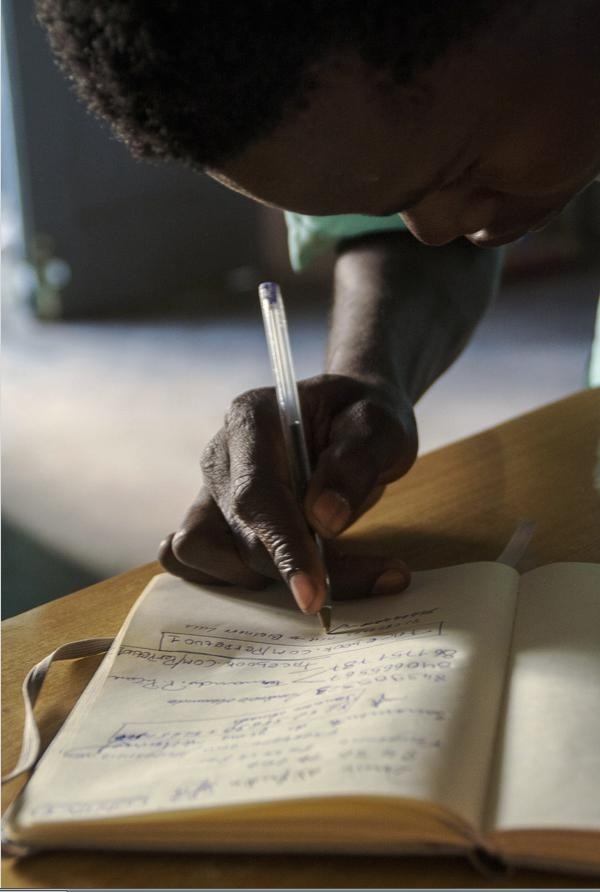 A dedicated student studying and writing notes